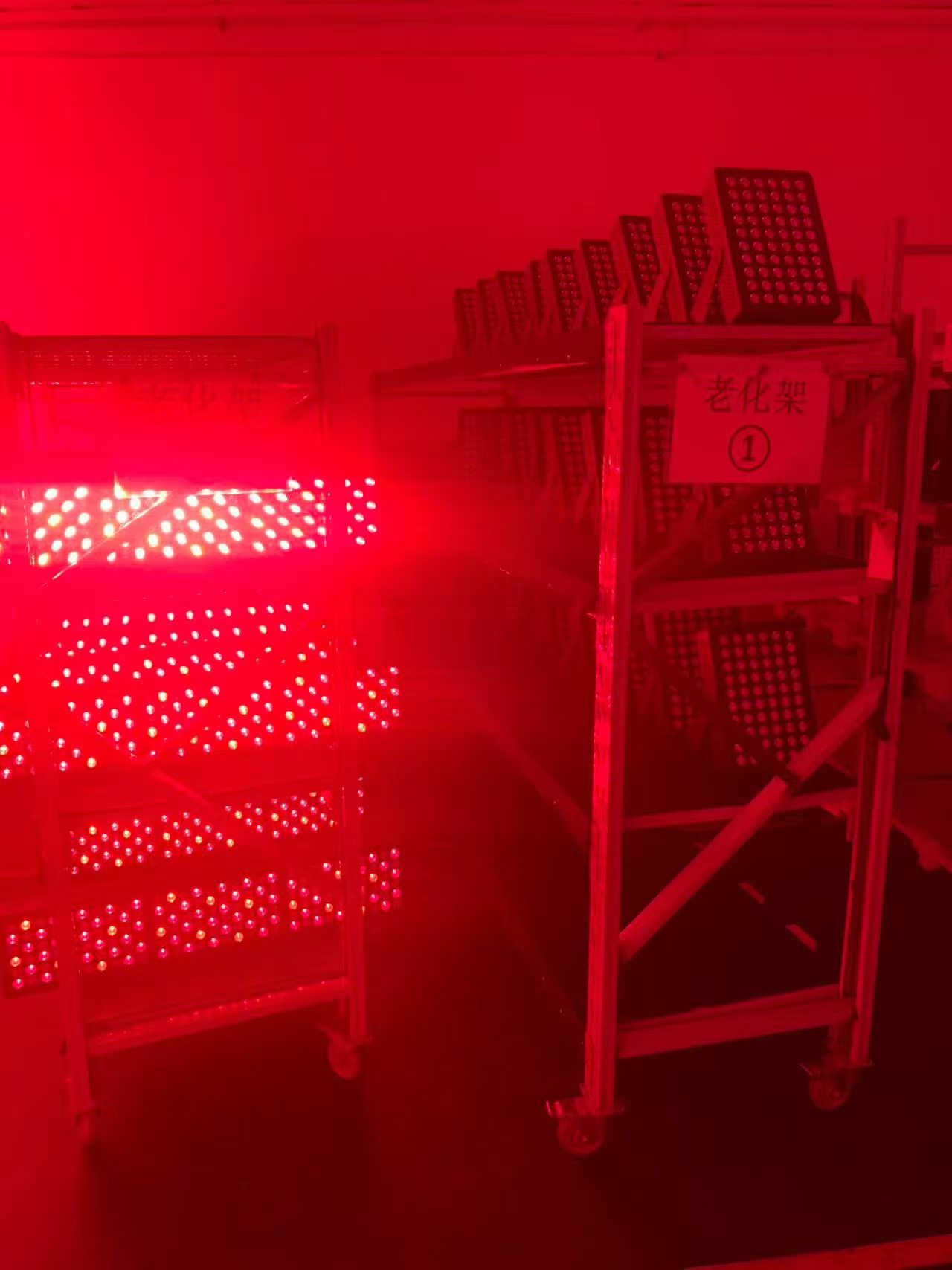 Red light therapy panels operating on aging test racks
